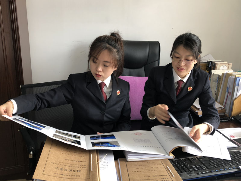 圖一：陳月（右一）告訴記者（左一）如何審查、分析案卷。