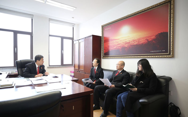 記者(右)旁聽(tīng)王志紅(左二)和院領(lǐng)導(dǎo)研究復(fù)雜案件