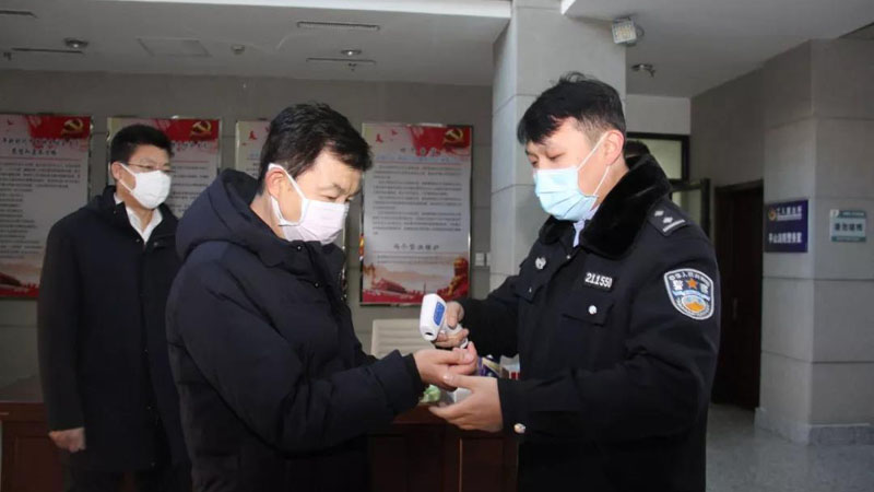 張學群（中）在本溪市平山區(qū)人民法院接受體溫測量