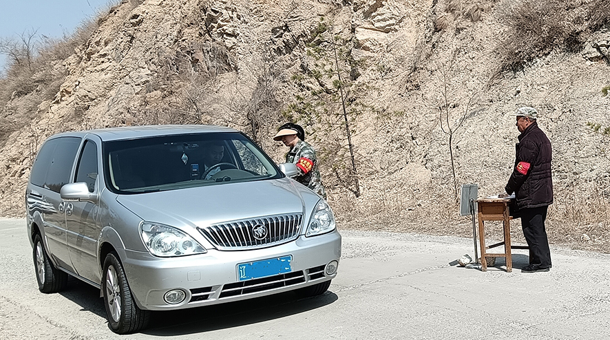 佟玲(右二)在對(duì)過往車輛檢查登記