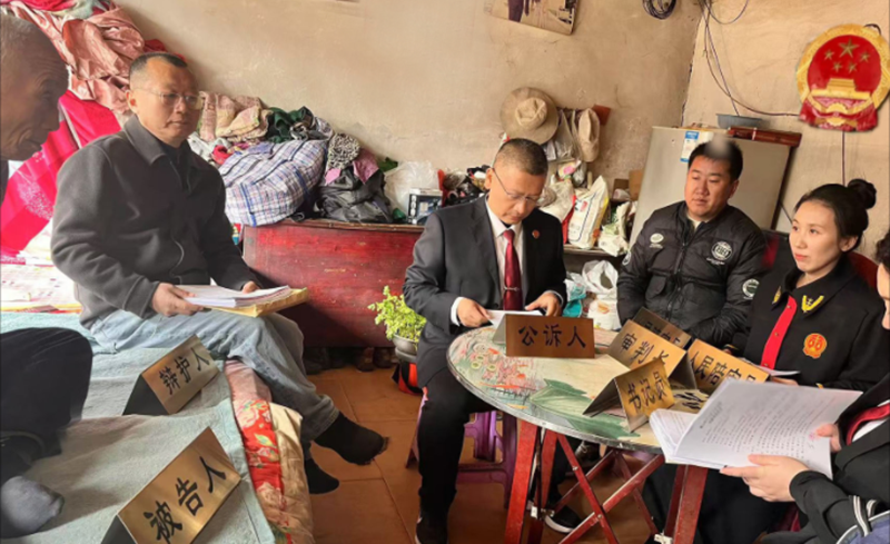 在岫巖滿族自治縣哈達碑鎮(zhèn)希林村的農(nóng)戶家里開展巡回審判