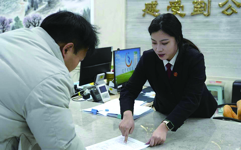 法院工作人員指導(dǎo)當(dāng)事人填寫材料1